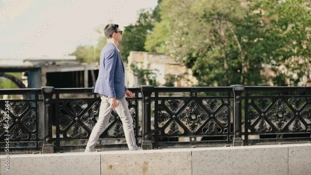 Portrait of confident businessman wearing in sunglasses and walking at street. Portrait of confident businessman wearing in sunglasses and walking at street.