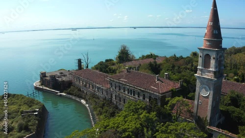 Aerial view of the plagued ghost island of Poveglia in the Venetian lagoon, opposite Malamocco along the Canal Orfano near Venice, Italy. photo