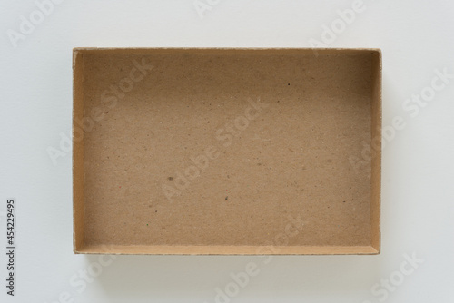 Obraz na płótnie shallow cardboard box isolated on a light background
