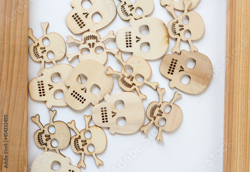 retro halloween wooden shapes (skulls and skull and crossbones) inside a wooden frame on white