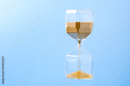 Hourglass on blue background