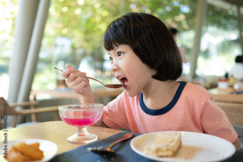 Asian children enjoy eating food 

