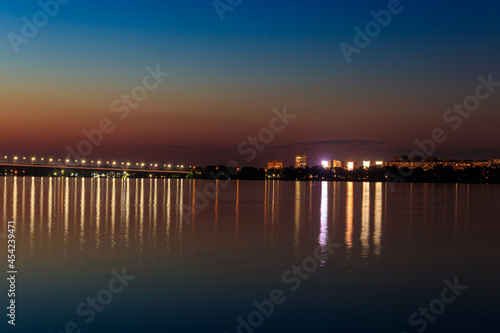 Night view of the Dnieper river and Dnipro city in Ukraine © olyasolodenko