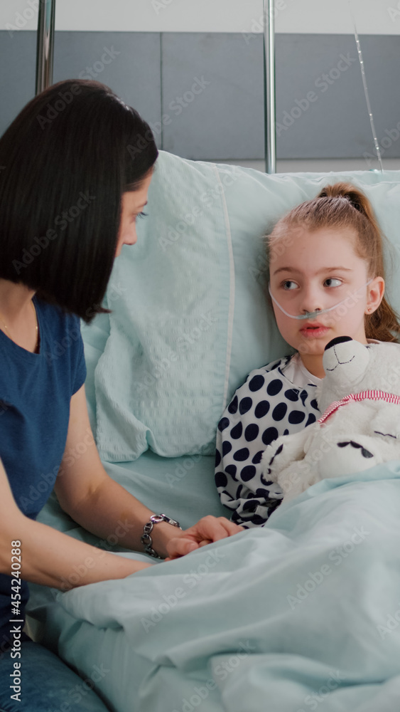 Mother explaining medication treatment to sick daughter during recovery ...