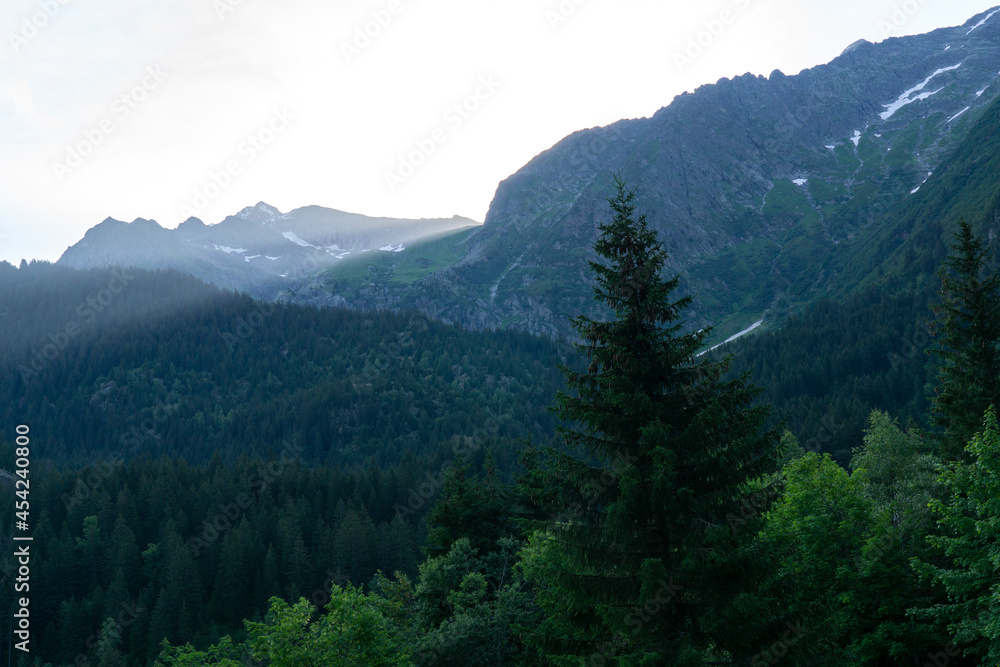 Fototapeta premium Panoramic view of relaxing mountain scenery with mountains in the background and meadow, grass on a nice, sunny day