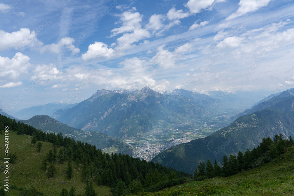 Panoramic view of relaxing mountain scenery with mountains in the background and meadow, grass on a nice, sunny day Panoramic view of relaxing mountain scenery with mountains in the background and meadow, grass on a nice, sunny day