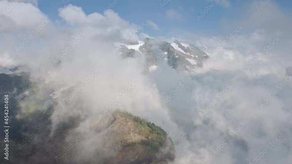 4K time lapse North Cascades and Mount Baker National park. Cinematic snow peaks with glaciers landscape through clouds at sunset. Nature, environment and ecology aerial footage, USA Canada mountains 4K time lapse North Cascades and Mount Baker National park. Cinematic snow peaks with glaciers landscape through clouds at sunset. Nature, environment and ecology aerial footage, USA Canada mountains