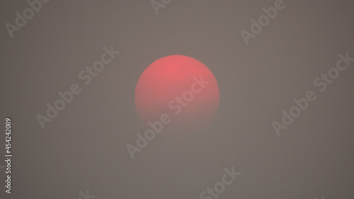 Red sun caused from air pollution smog and haze. Smoke from forest fires and environment climate change