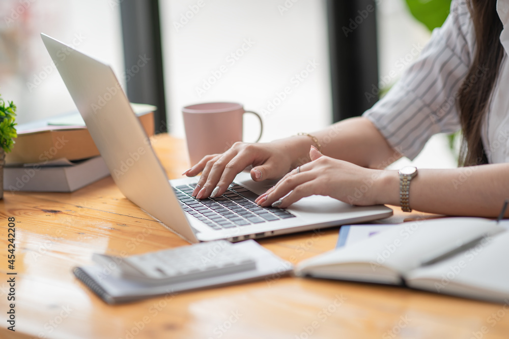 Woman working at home office hand on keyboard close up. Woman working at home office hand on keyboard close up.