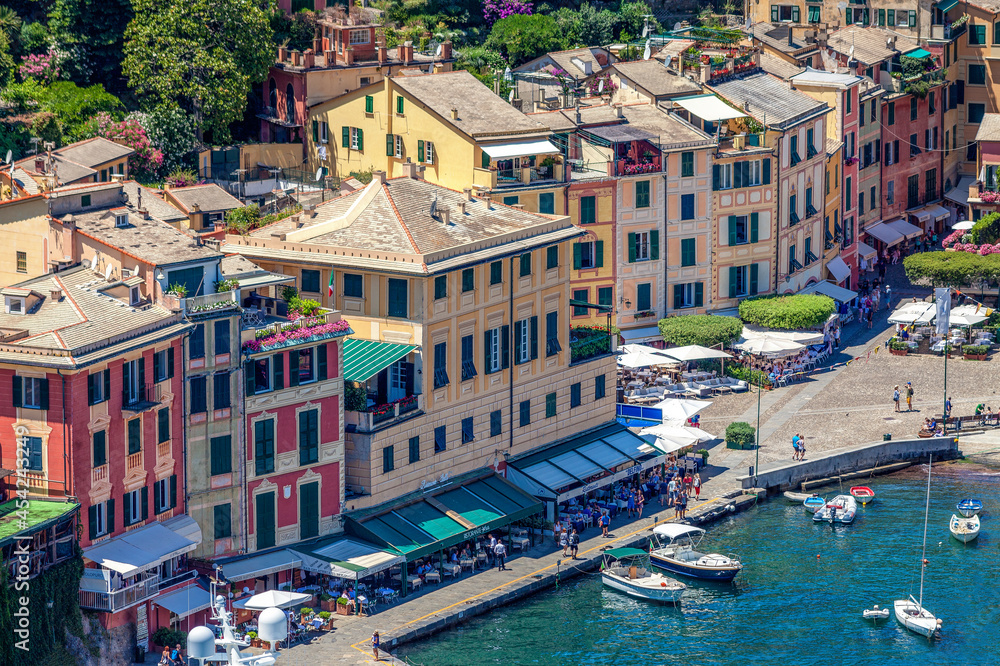 Overview of Portofino seaside area with traditional colourful houses, harbour with docked boats, view from Castello Brown, Liguria, Italy