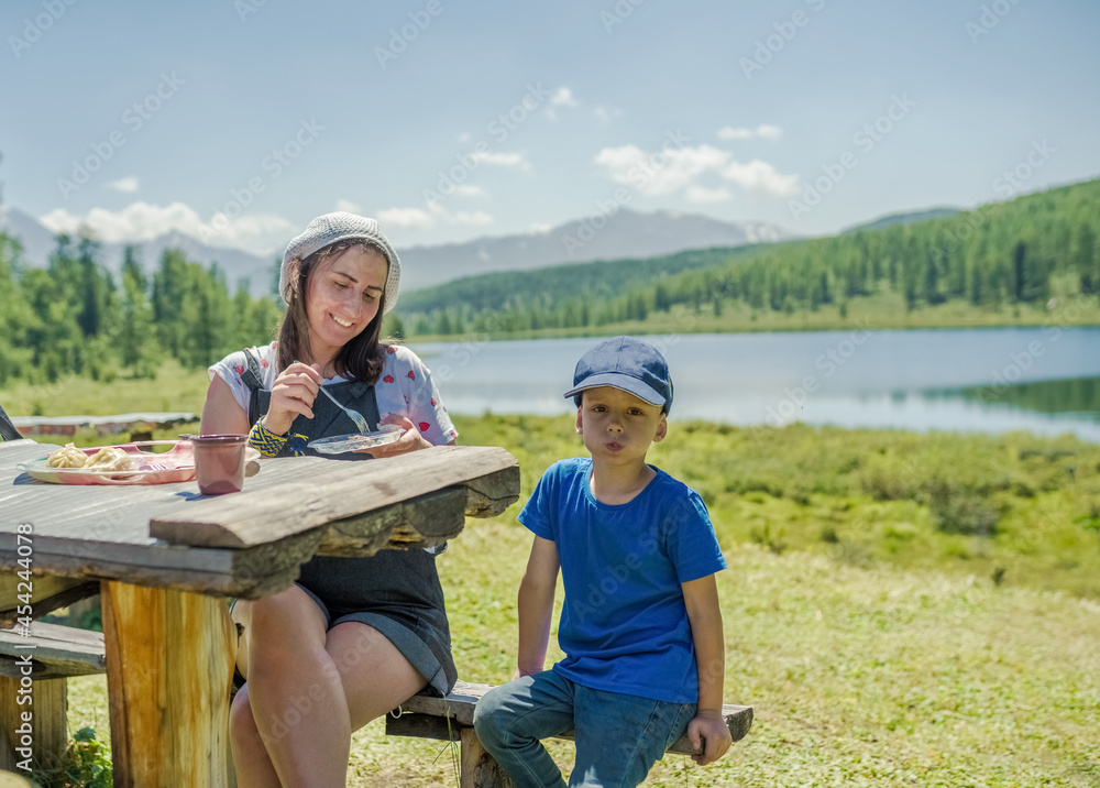 People have lunch on the lake shore People have lunch on the lake shore