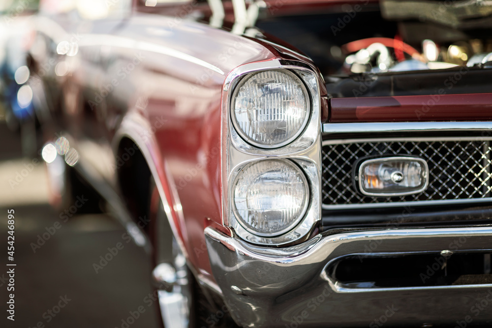 Classic car show, close-up on vehicle headlights, vintage color