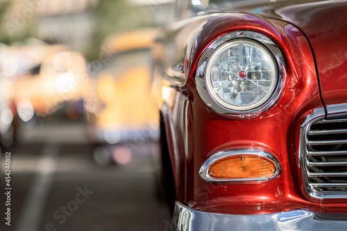 Classic car show, close-up on vehicle headlights, vintage color