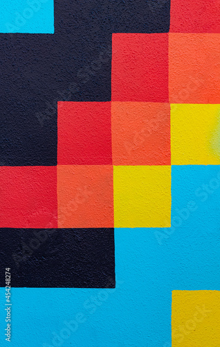 abstract colorful geometric pattern on a concrete wall of a house