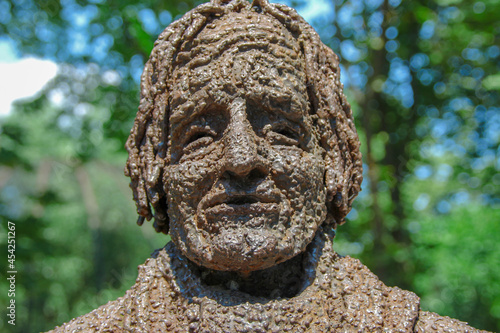 Metal monument to a man in the park photo