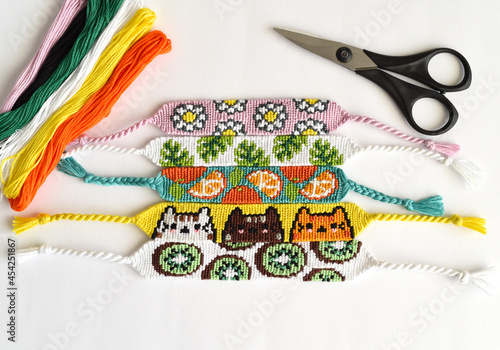 Woven DIY friendship bracelets handmade of embroidery floss with knots, alpha patterns © Tatiana