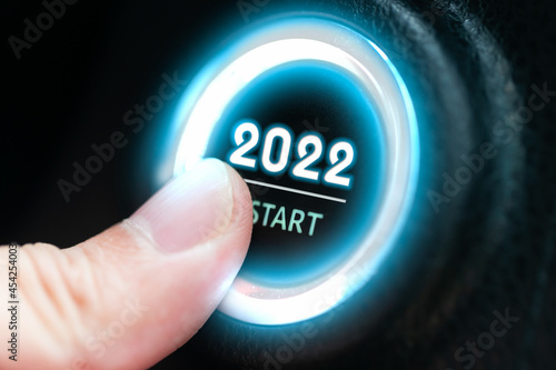 Finger press ignition button with the text 2022 start. business start-up concept.
