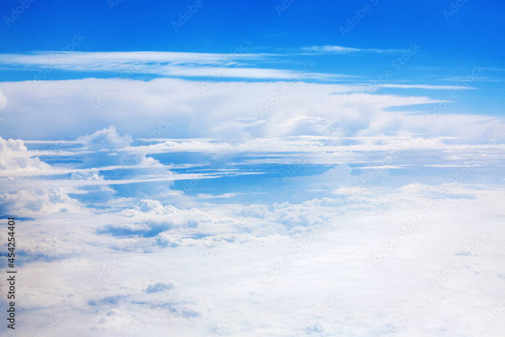 White clouds on blue sky background view from above, airplane flight landscape, beautiful aerial cloudscape, skies backdrop, fluffy cloud texture, sunny heaven, cloudy weather, cloudiness, copy space