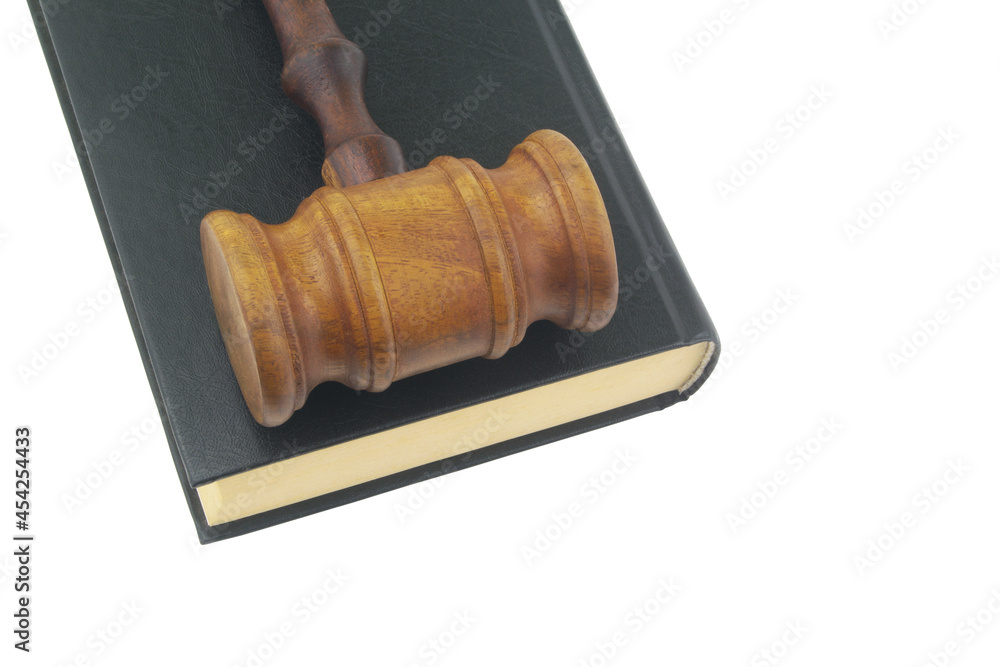 Wooden gavel and legal book isolated on white