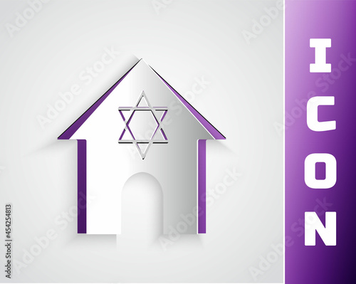 Paper cut Jewish synagogue building or jewish temple icon isolated on grey background. Hebrew or judaism construction with David star. Paper art style. Vector