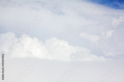 White cumulus clouds blue sky background closeup beautiful aerial cloudscape backdrop, cloudy skies from above, sunny heaven fluffy cloud texture, airplane flight cloudiness landscape view, copy space