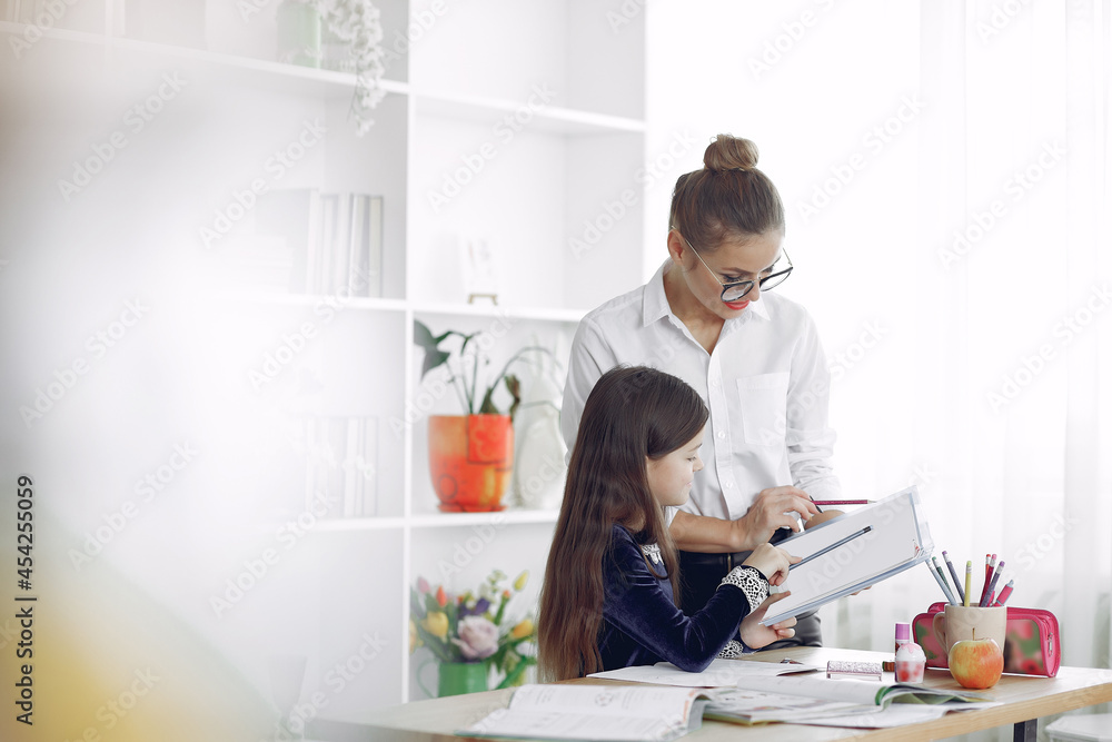 Tutor with litthe girl studying at home Tutor with litthe girl studying at home