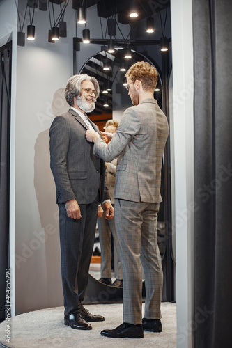 Senior man choosing a new suit in a store