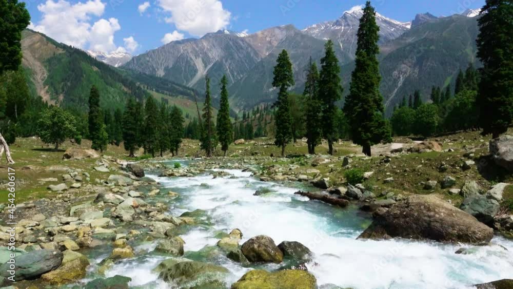 Beautiful mountain scenery. Blue sky, clear river with rocks. In-depth trip on the Sonamarg Hill Trek in Jammu and Kashmir, India, June 2018 Beautiful mountain scenery. Blue sky, clear river with rocks. In-depth trip on the Sonamarg Hill Trek in Jammu and Kashmir, India, June 2018