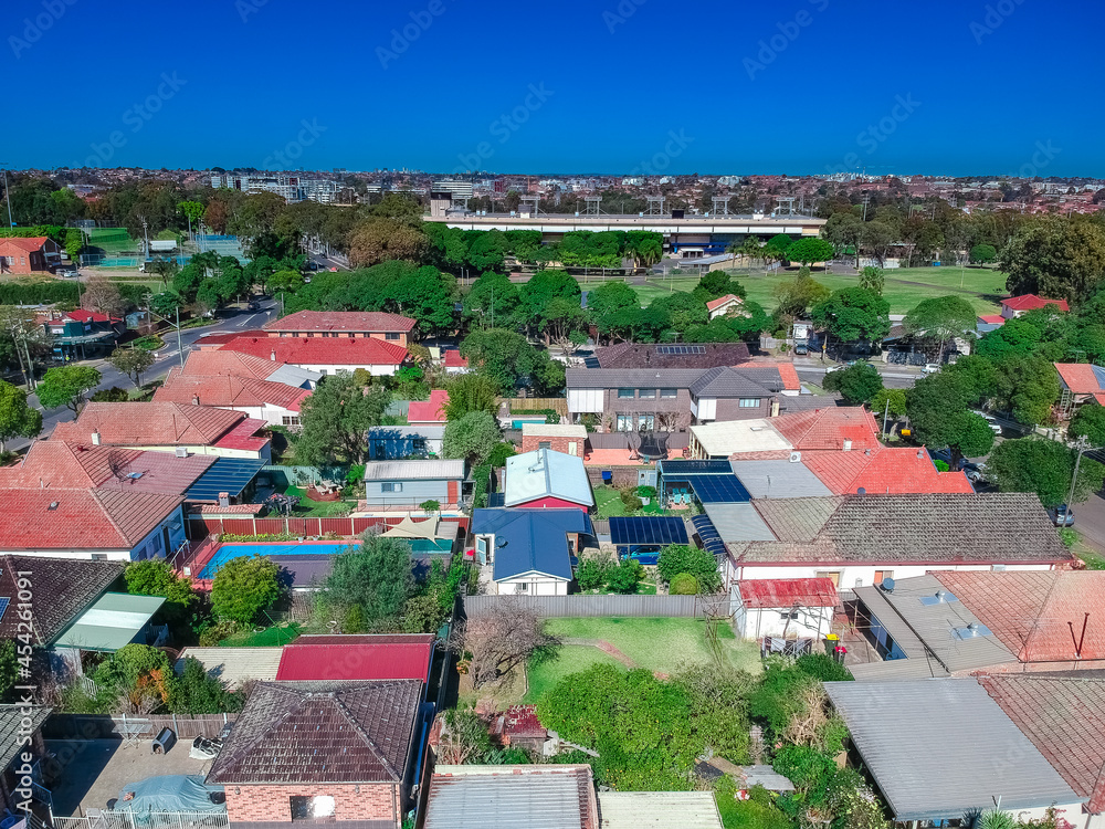 Fototapeta premium Panoramic Aerial Drone view of Suburban Sydney housing, roof tops, the streets and the parks NSW Australia