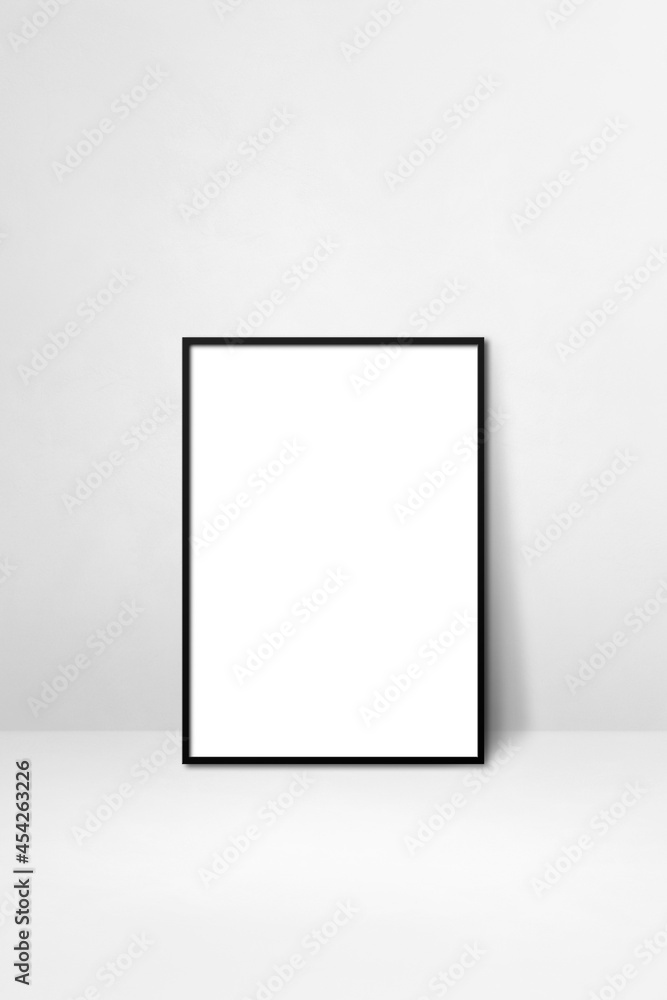 Black picture frame leaning on a white wall Black picture frame leaning on a white wall