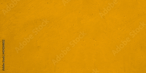 Urban background rusty cement or stone painting of gold yellow.