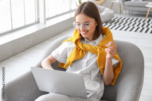 Young woman with laptop at ...