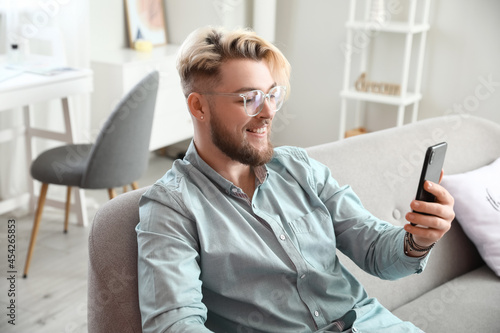 Young man with mobile phone...