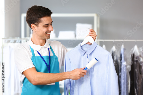 Male worker cleaning clothe...