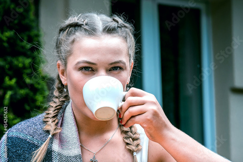 Young woman drinking coffee in a cafe outdoor