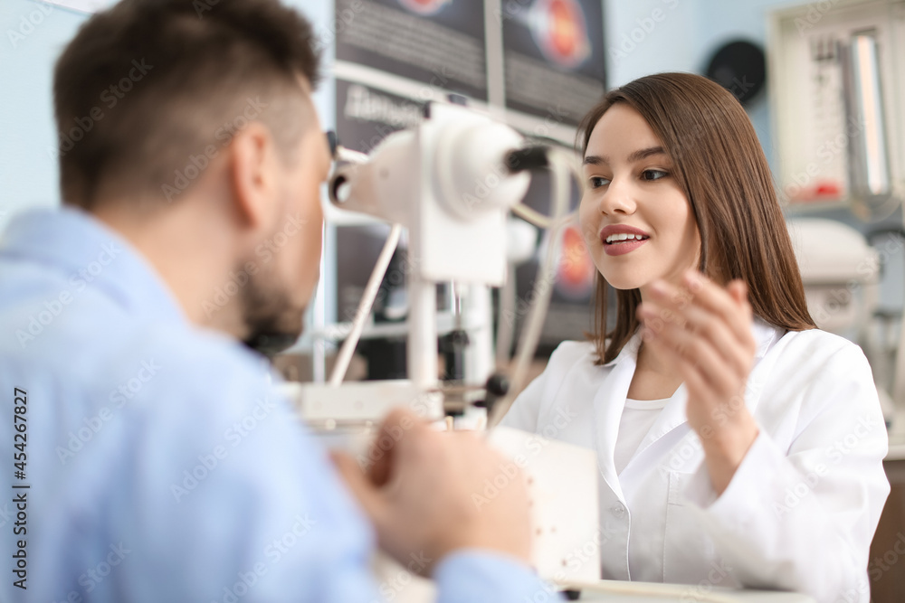 Ophthalmologist examining man in clinic Ophthalmologist examining man in clinic
