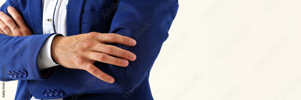 Male hands in suit crossed on chest closeup