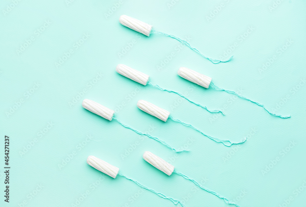 Tampons on color background, top view