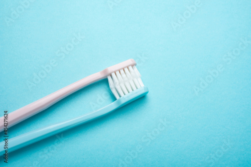 Two toothbrushes on blue background