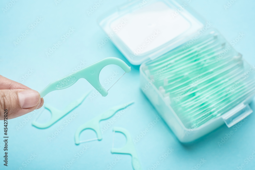 Hand holding a dental floss background material Hand holding a dental floss background material