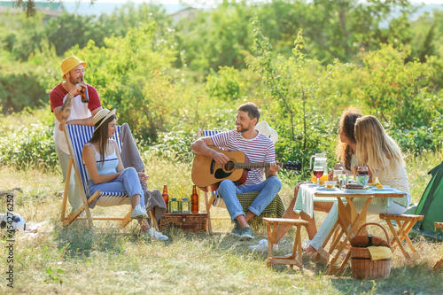 Young man playing guitar at...