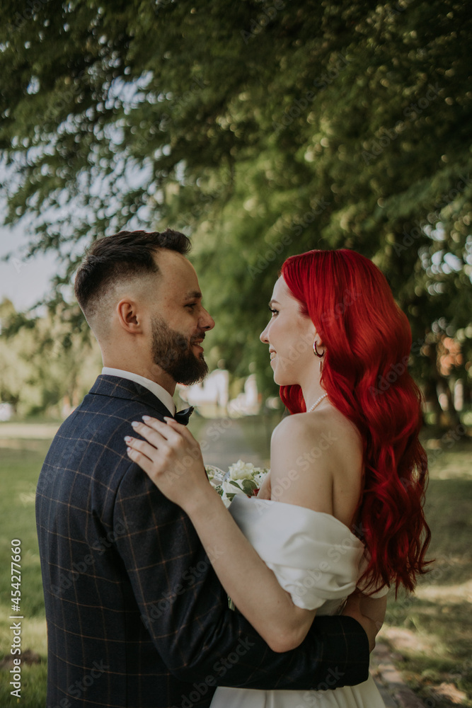 Wedding day. Happy bride and groom hugging and laughing Red hair diversity Wedding day. Happy bride and groom hugging and laughing Red hair diversity