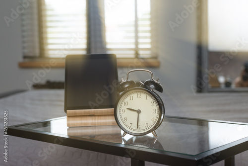 Vintage style alarm clock and modern notepad