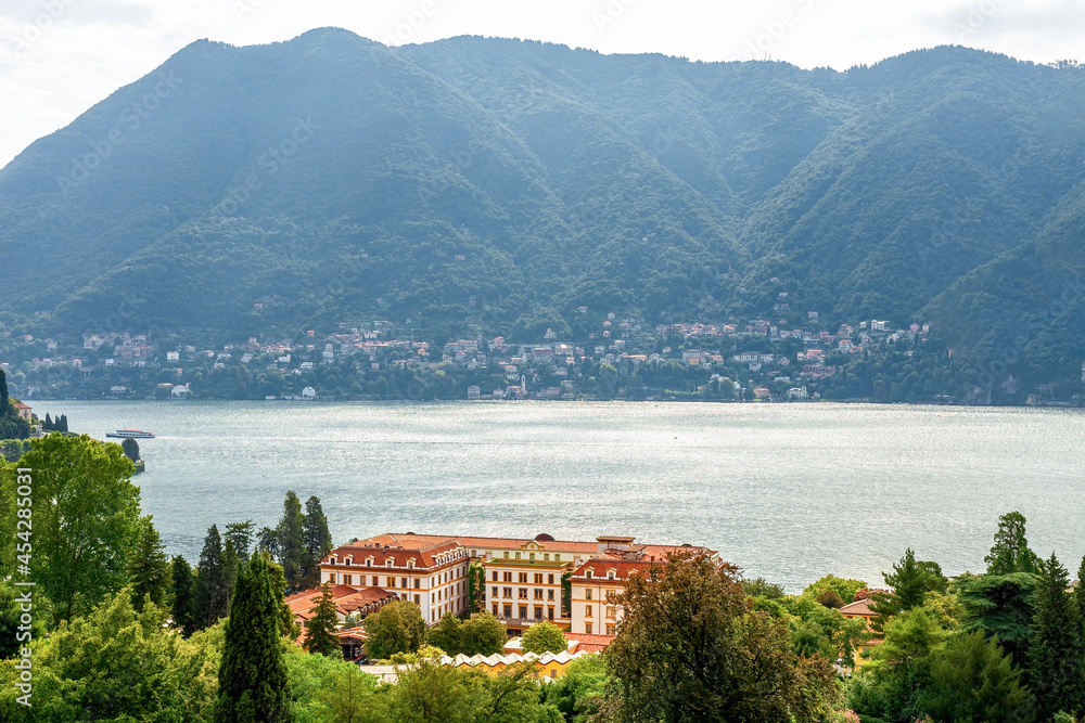 Como lake. Lake in the mountains. Lake in the mountains. City on the slope of the mountains. Beautiful summer seascape with blurred background. Card. Photo