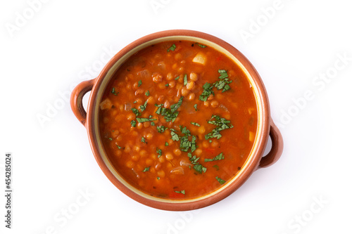 Red lentil soup isolated on white background. Top view