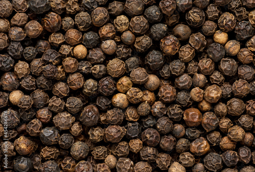 Black pepper grains as background close up Black pepper grains as background close up