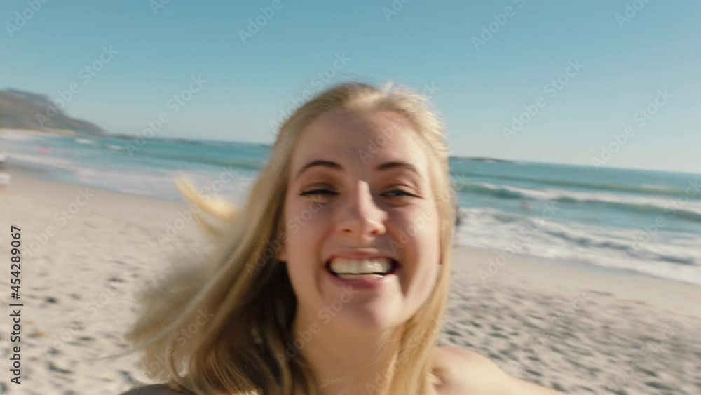 beautiful woman having video chat on beach girl waving at camera sharing summer vacation using smartphone showing travel adventure having fun holiday experience beautiful woman having video chat on beach girl waving at camera sharing summer vacation using smartphone showing travel adventure having fun holiday experience