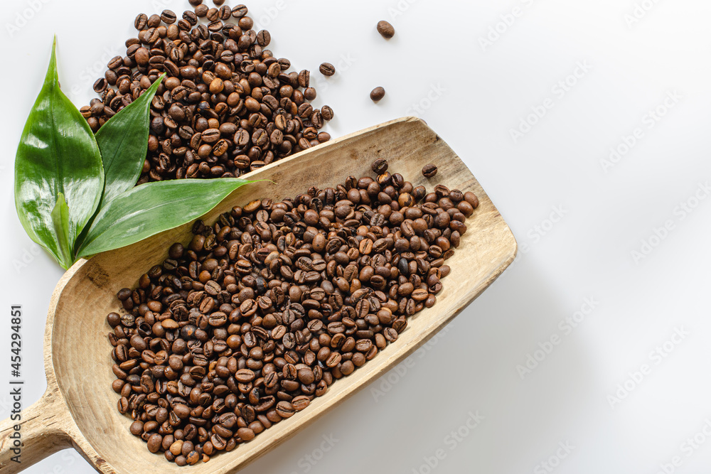 coffee beans lie in a wooden large spoon coffee beans lie in a wooden large spoon