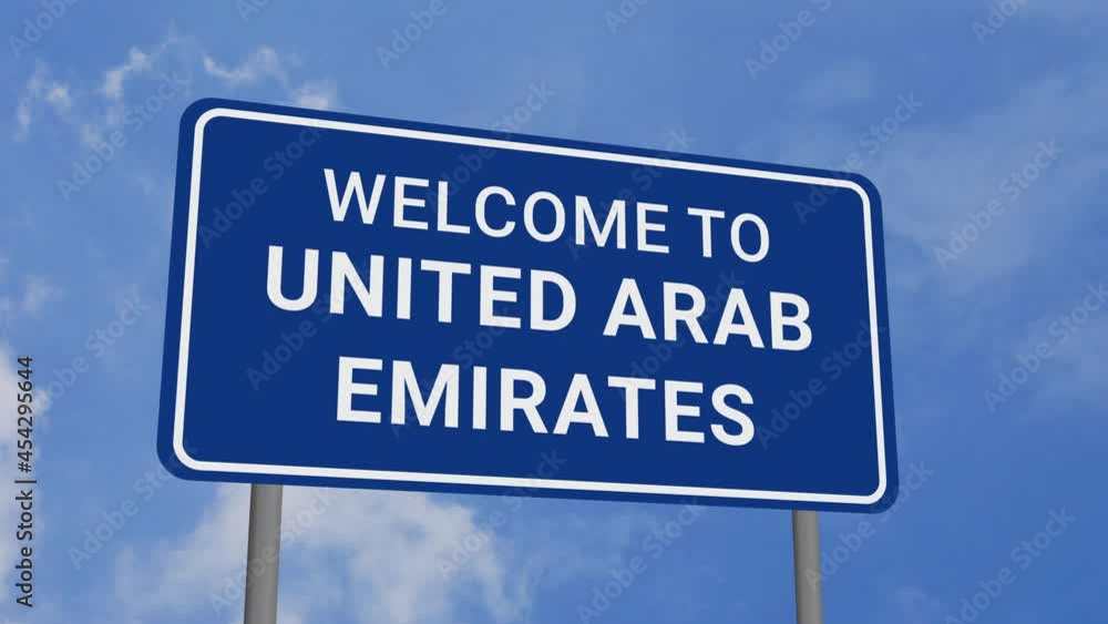 Welcome to United Arab Emirates Road Sign on Clear Blue Sky with Rapid Moving Clouds Welcome to United Arab Emirates Road Sign on Clear Blue Sky with Rapid Moving Clouds