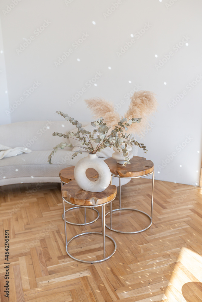 expensive modern light luxury interior design of a spacious living room with wooden elements and white walls. filled with original and unusual decorative things